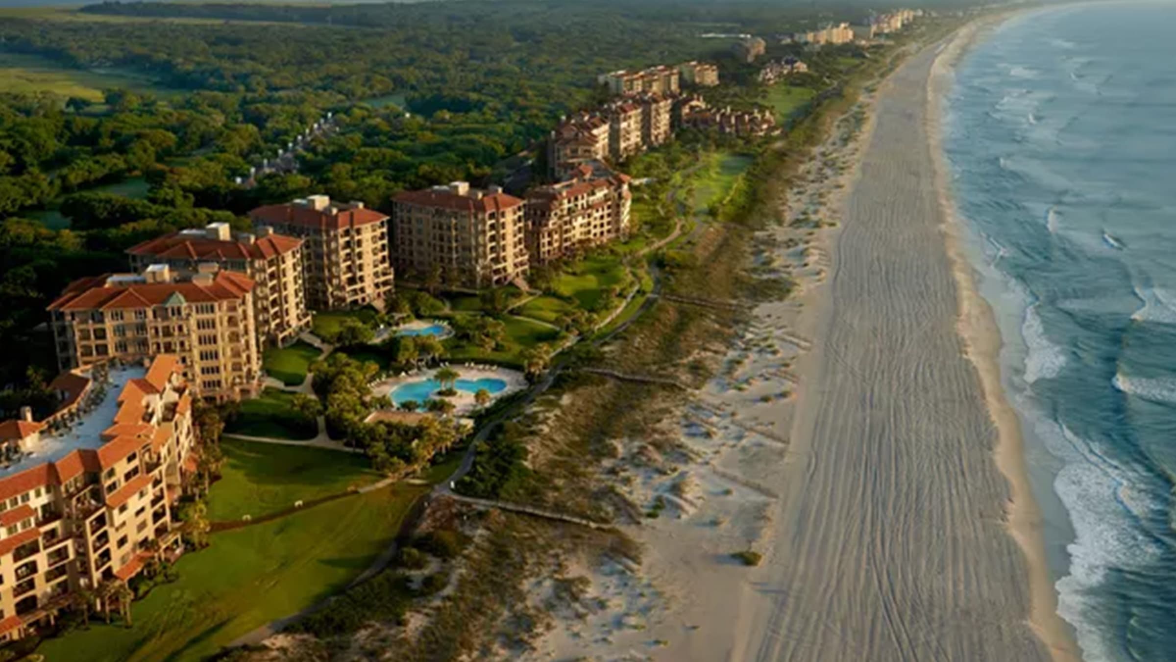 Aerial view of Amelia Island, Florida showcasing oceanfront resorts, sandy beaches, and the scenic Atlantic coastline near Golden Isles Junk Removal.