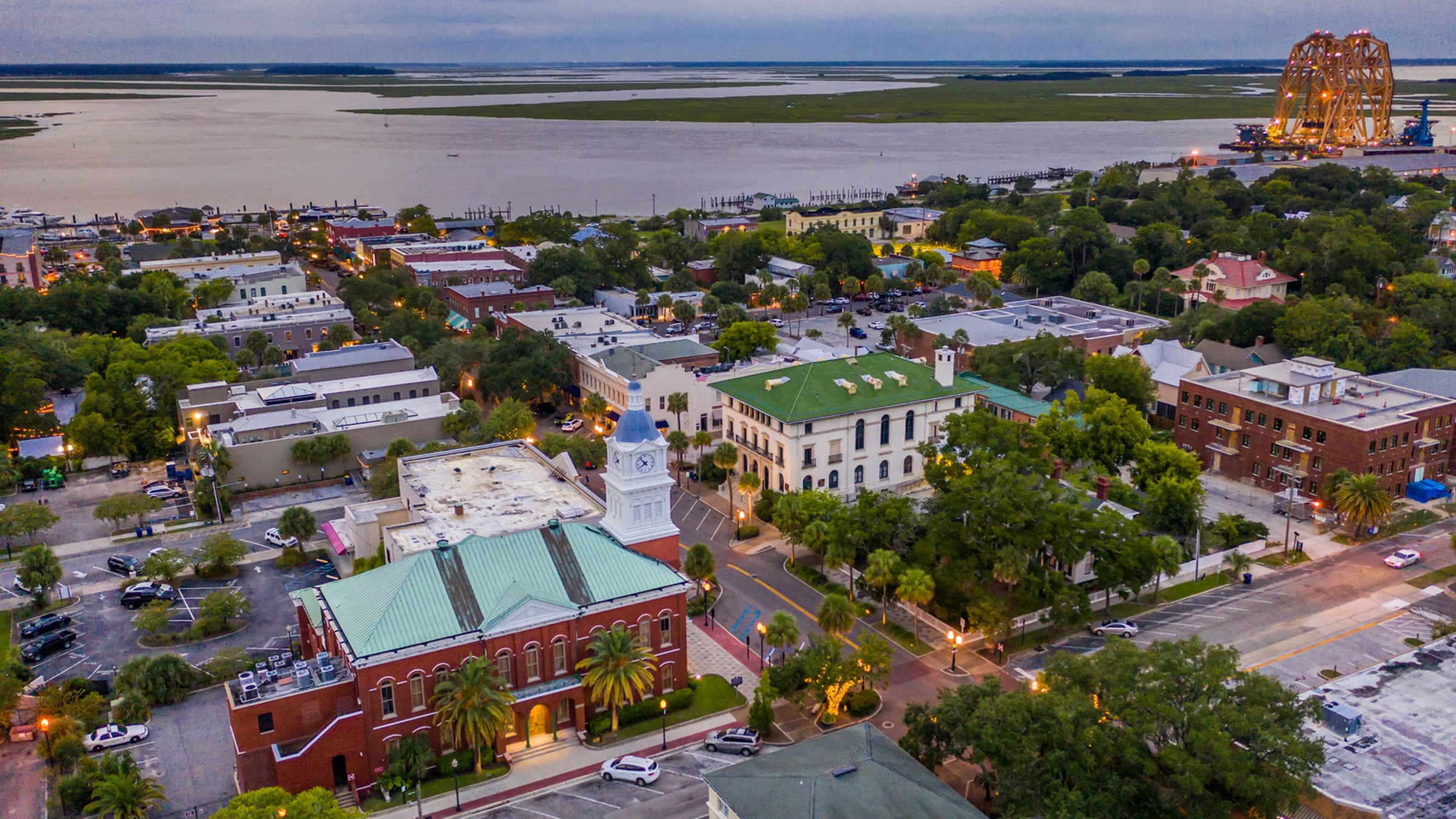 Aerial view of historic downtown Fernandina Beach, Florida overlooking the waterfront, city streets, and coastal marshes served by Golden Isles Junk Removal.